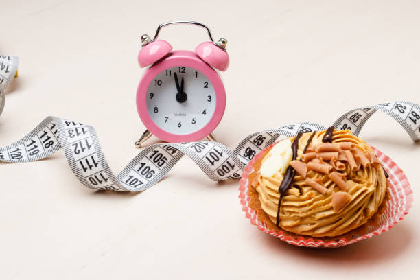 istock Sweet food measuring tape and clock on table 682581648