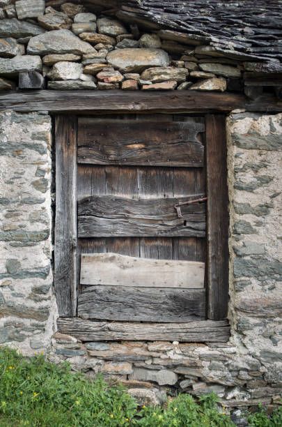 istock Weathered Wood Door in a Primitive Stone Hut 682585368