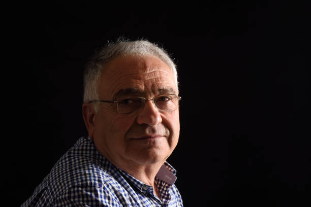 istock Portrait of a senior man with black background 682585668