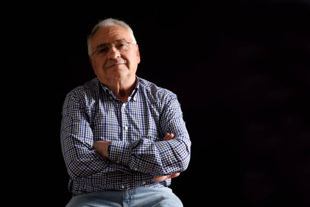 istock Portrait of a senior man with black background 682585972