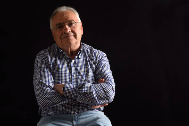 istock Portrait of a senior man with black background 682586196