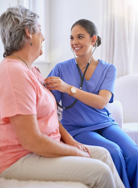 Sounds like a steady, healthy beat to me Cropped shot of a nurse examining a senior patient with a stethoscope taking pulse stock pictures, royalty-free photos & images