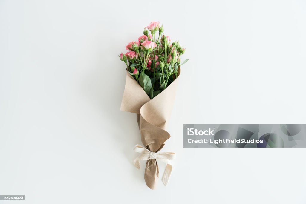 Pink Roses Bouquet In Kraft Paper Isolated On White With Copy
