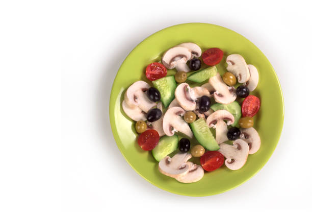 top view flat lay mix fresh vegetable with chinese cabbage,mushroom,tomato,green peas,cucumber with copy space on wood round plate dark green background.idea for vegan healthy food.