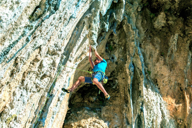 istock Rock Climber hanging on unusual rocky formation 682614034