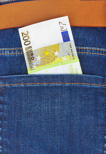 Money in jeans pocket - shopping background