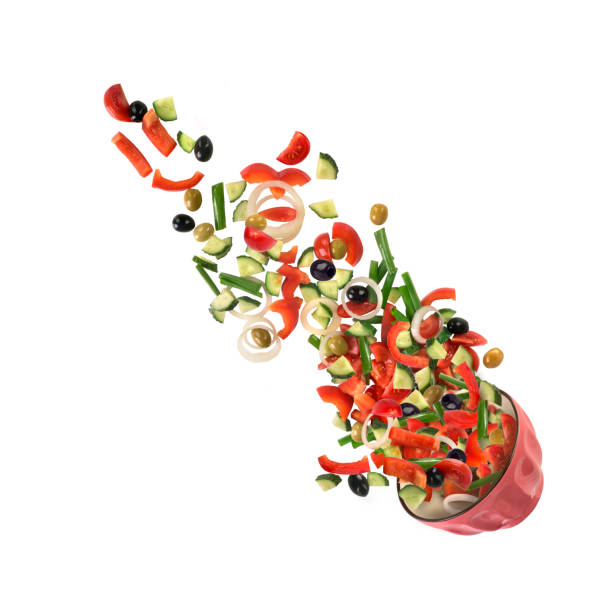 Falling salad of vegetables on white background
