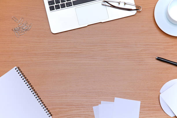 istock Office table with laptop, notepad and coffee cup. View from above with copy space 682621398
