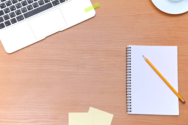 istock Office table with laptop, notepad and coffee cup. View from above with copy space 682622224