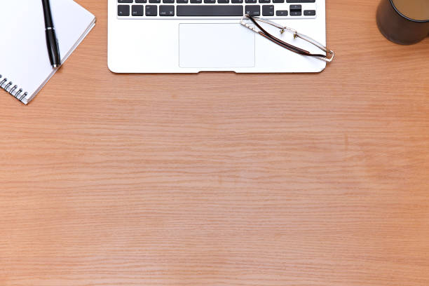 istock Office table with laptop, notepad and coffee cup. View from above with copy space 682622360