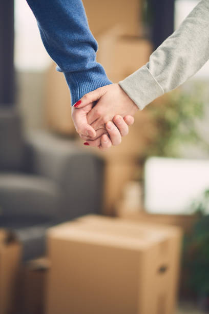 istock Close up of hands with moving boxes in background 682623214