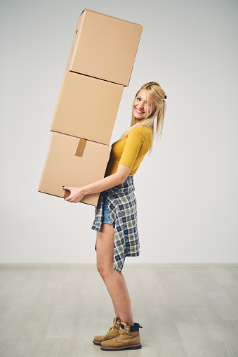 Woman Carrying Cardboard Moving Boxes