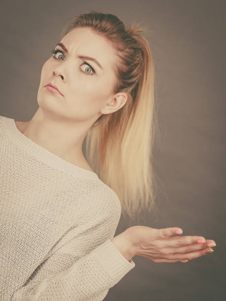 istock Confused young blonde woman gesturing with hands 682628460