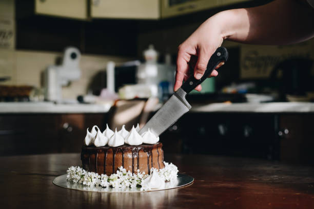 istock hand cut with knife piece of cake 682631678