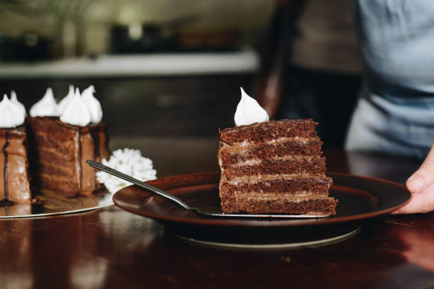 istock hand cut with knife piece of cake 682632866