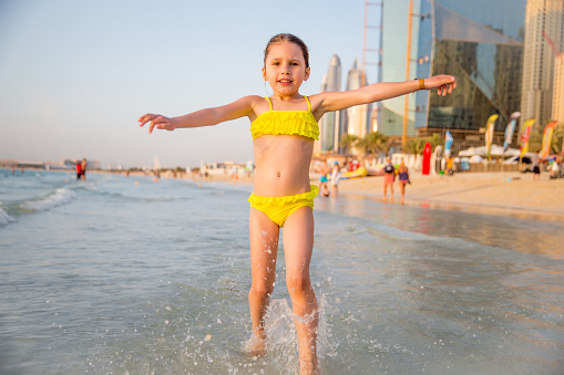 Little Girl Enjoying Running On The Dubai Beach