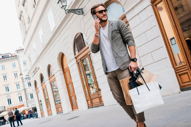 istock handsome man in shopping talking on his phone 682639812