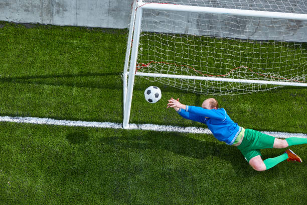istock Soccer football goalkeeper making diving save 682647454