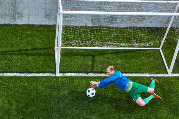 istock Soccer football goalkeeper making diving save 682647592