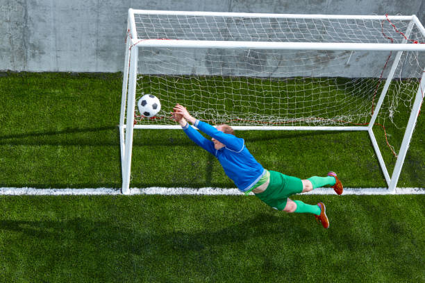 istock Soccer football goalkeeper making diving save 682647736