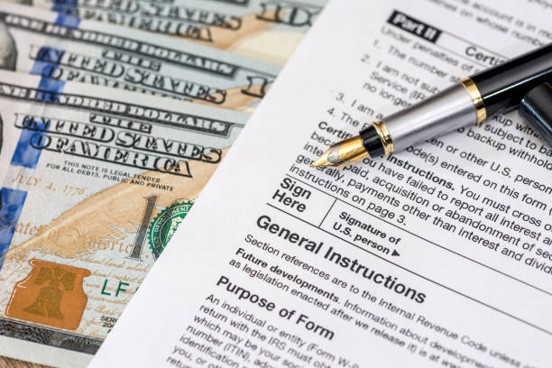 istock tax form - w9 - with dollar and pen. 682654080