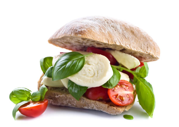istock Ciabatta with mozzarella, tomato and basil isolated on white 682655368