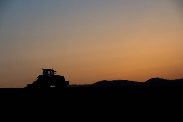 istock Farm work at dusk with beautiful sunset sky 682672160