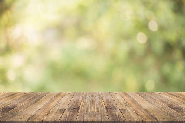 istock table top on green blurred  background,Space for placing products 682676478