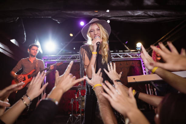 istock Cheerful female singer performing on stage at nightclub 682683098