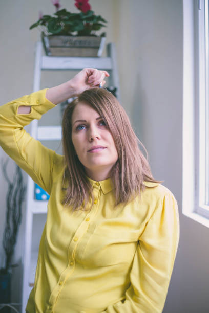 istock pretty girl sitting at desk in bright office, 682696496