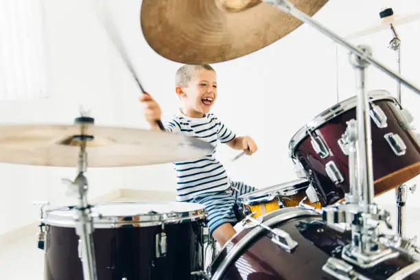 Photo of Little boy playing drums