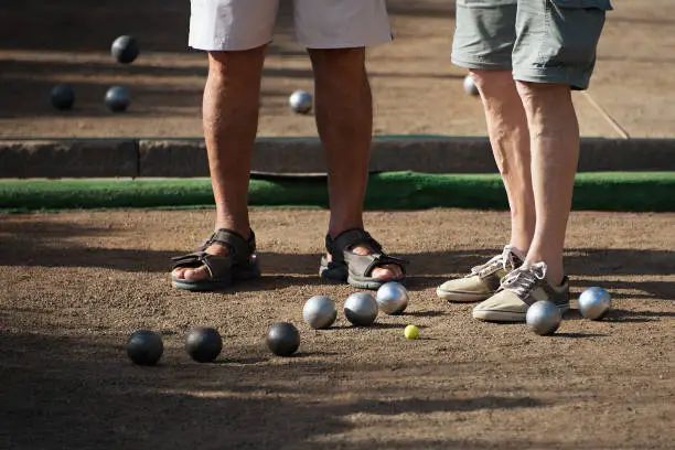 Photo of Old mens playing petanque in a city park