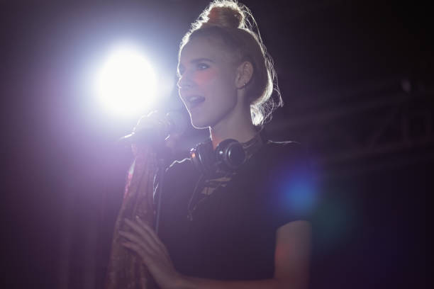 istock Young female singer performing at nightclub 682704158