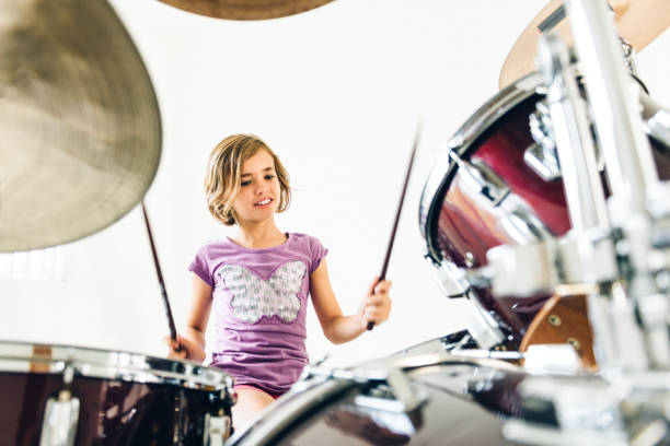 istock Little girl playing drums 682704194