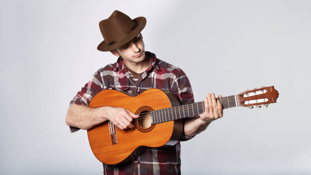 istock man is playing the guitar in hat on white 682705820