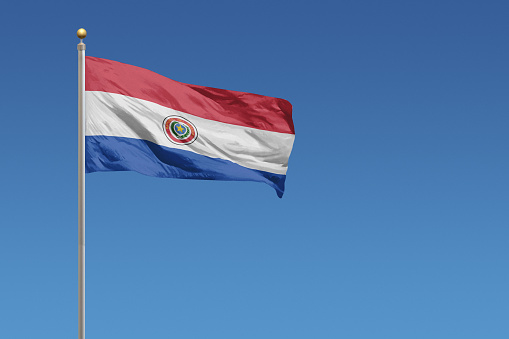 Flag of Paraguay in front of a clear blue sky