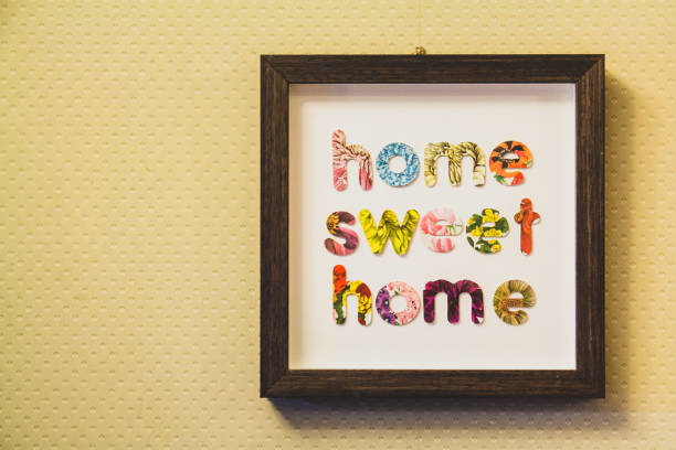 Framed letters home sweet home hung on a wall stock photo