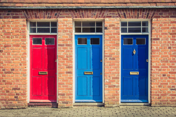 Three differently coloured front doors at the entrance of old English terraced houses. Canterbury, England. Three differently coloured front doors at the entrance of old English terraced houses. Canterbury, England. canterbury uk stock pictures, royalty-free photos & images