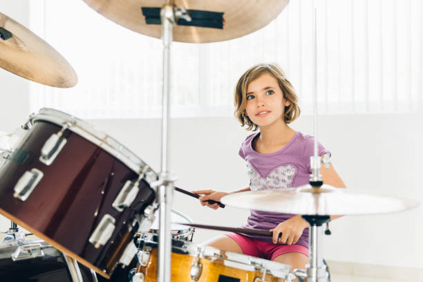 istock Little girl playing drums 682714726