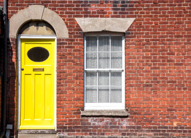 Yellow front door of an old traditional English terraced house. Canterbury, England. stock photo