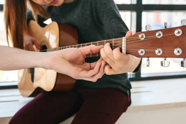 istock Learning to play the guitar. Music education. 682731086