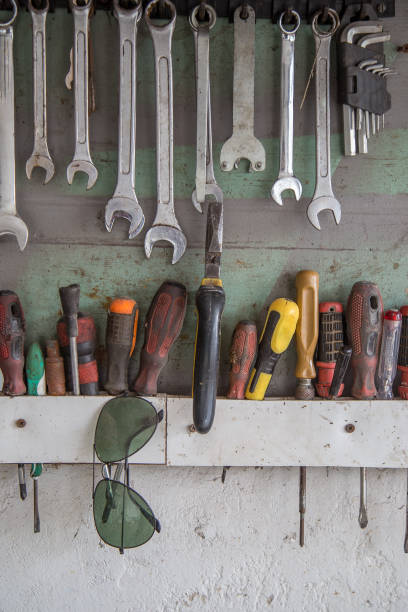istock Set of wrenches and screwdrivers hanging on the workshop or garage wall 682732166