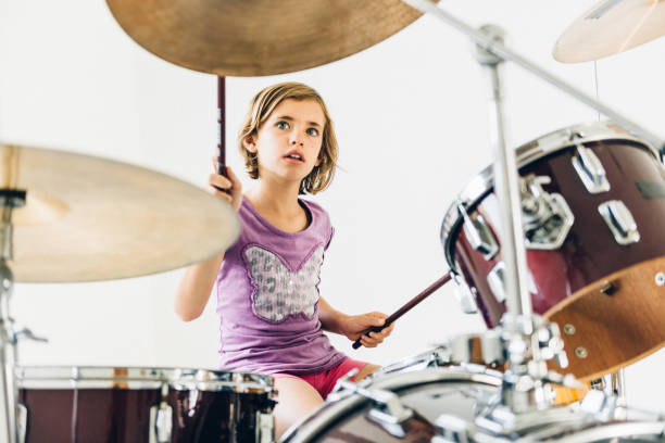 istock Little girl playing drums 682732388