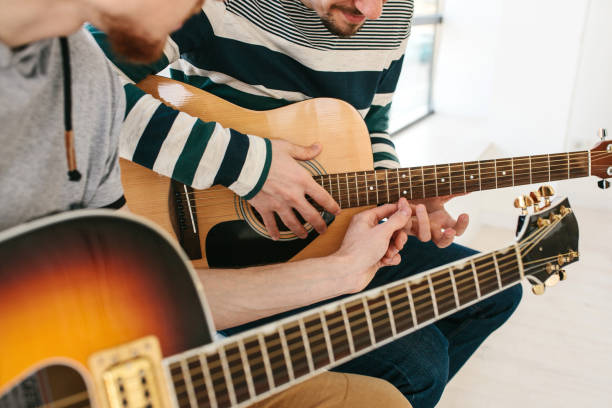 istock Learning to play the guitar. Music education. 682736572