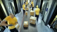 istock TIME-LAPSE Workers taking packages off the conveyor belt for further distribution 682739192