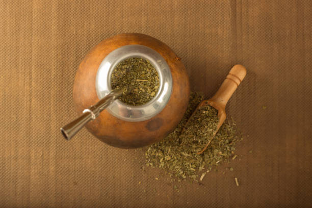 istock Kalabash with yerba mate and a wooden spoon on a rag background 682746836