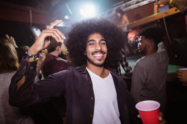 istock Happy man with drink in nightclub 682756546