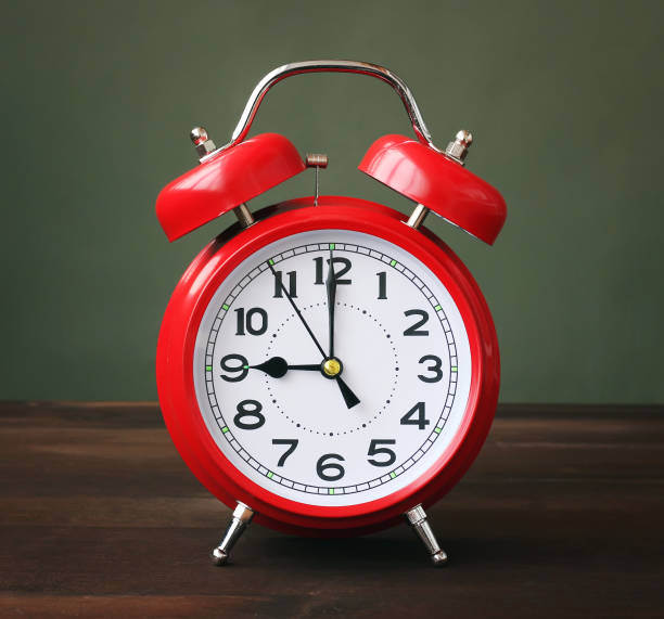 istock The red alarm clock showing 9-00 hours. 682759118