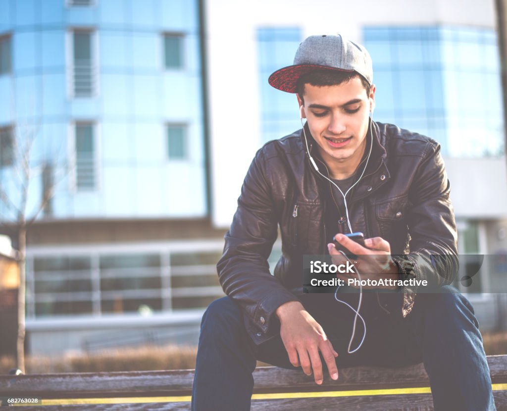 Young man with mobile phone Cap - Hat Stock Photo
