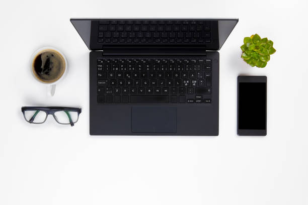istock Contemporary white office desk with Laptop and Coffee Cup 682763230